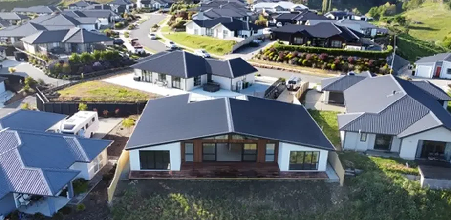 AT Lowe Construction builders on site discussing a residential building project on the West Coast and Tasman